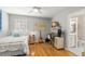 Cozy bedroom featuring wood floors, natural light, and a full workstation at 8236 36Th N Ave, St Petersburg, FL 33710