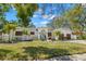 Inviting single-story home featuring a lush green lawn, mature palms, and an attached two-car garage at 8236 36Th N Ave, St Petersburg, FL 33710