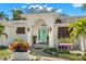 Close-up of the entrance with an eye-catching door, decorative plants, and manicured landscaping at 8236 36Th N Ave, St Petersburg, FL 33710