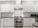 Close-up view of kitchen featuring stainless steel appliances, white cabinets, and granite countertops at 8236 36Th N Ave, St Petersburg, FL 33710