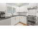 Modern kitchen featuring stainless steel appliances, white cabinets and counters, and lots of natural light at 8236 36Th N Ave, St Petersburg, FL 33710