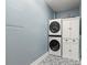 Functional laundry room features stacked washer and dryer, storage cabinet, and stylish tile floors at 8236 36Th N Ave, St Petersburg, FL 33710