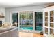 Sunlit living room showcasing sliding doors with views of the screened-in pool area at 8236 36Th N Ave, St Petersburg, FL 33710