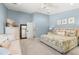 Spacious main bedroom featuring soft blue walls, a king bed, and a comfortable seating area at 8236 36Th N Ave, St Petersburg, FL 33710