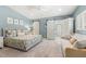 Serene main bedroom with a king-sized bed, sitting area, and barn doors to the bathroom at 8236 36Th N Ave, St Petersburg, FL 33710