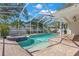 Inviting in-ground pool with spa and screened enclosure, surrounded by lush landscaping at 8236 36Th N Ave, St Petersburg, FL 33710