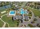 Top-down view of the community pool area, featuring distinct pools, lounge areas, and landscaping at 8780 Flourish Dr, Land O Lakes, FL 34637