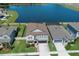 Aerial view of home with a large backyard, pool, and access to a beautiful lake at 8780 Flourish Dr, Land O Lakes, FL 34637