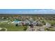 Aerial view of community amenities showcasing the pool, clubhouse and surrounding residential homes at 8780 Flourish Dr, Land O Lakes, FL 34637