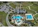 Aerial shot of the clubhouse with pools, a lazy river, and well-maintained grounds in a Primary-planned community at 8780 Flourish Dr, Land O Lakes, FL 34637