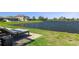 Enjoy a serene backyard view with a peaceful lake and a comfortable lounge chair on a brick patio at 8780 Flourish Dr, Land O Lakes, FL 34637