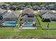 Aerial view of backyard featuring a screened-in pool, patio, and well-kept landscaping at 8780 Flourish Dr, Land O Lakes, FL 34637