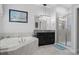 This bathroom has a soaking tub, walk-in shower, and granite counters at 8780 Flourish Dr, Land O Lakes, FL 34637