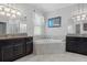 This bathroom has dual sinks, granite counters, a soaking tub and walk-in shower at 8780 Flourish Dr, Land O Lakes, FL 34637