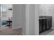 Bathroom with dark cabinets, double sink and granite countertop, located off a hallway at 8780 Flourish Dr, Land O Lakes, FL 34637