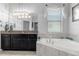This bathroom has a soaking tub, granite counters, and lots of vanity storage at 8780 Flourish Dr, Land O Lakes, FL 34637