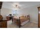 Cozy bedroom with a ceiling fan, a desk, and a comfortable bed at 8780 Flourish Dr, Land O Lakes, FL 34637