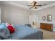 This bedroom features a tray ceiling and an adjacent bathroom with soaking tub at 8780 Flourish Dr, Land O Lakes, FL 34637