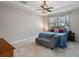 Bright bedroom features a tray ceiling, large windows, and a decorative chandelier at 8780 Flourish Dr, Land O Lakes, FL 34637
