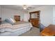 Bedroom featuring a decorative dresser and a wooden bed frame at 8780 Flourish Dr, Land O Lakes, FL 34637