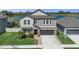 Beautiful two-story home with well-maintained lawn and views of a serene lake at 8780 Flourish Dr, Land O Lakes, FL 34637
