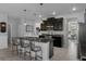 Modern kitchen featuring stainless steel appliances, granite countertops, and dark wood cabinets at 8780 Flourish Dr, Land O Lakes, FL 34637