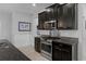 Modern kitchen featuring stainless steel appliances, granite countertops, and dark cabinetry at 8780 Flourish Dr, Land O Lakes, FL 34637