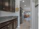 Bright, open kitchen featuring stainless steel appliances, granite countertops, and dark cabinets at 8780 Flourish Dr, Land O Lakes, FL 34637