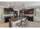 Spacious kitchen with granite counters, stainless appliances, breakfast bar, and dark cabinetry at 8780 Flourish Dr, Land O Lakes, FL 34637