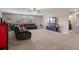 Spacious living room featuring plush seating, natural light, and an open floor plan at 8780 Flourish Dr, Land O Lakes, FL 34637