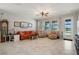 Cozy living room with comfortable seating and views of the lake and pool area at 8780 Flourish Dr, Land O Lakes, FL 34637