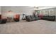 Spacious living room features a plush sectional sofa, carpeted floors and plenty of natural light at 8780 Flourish Dr, Land O Lakes, FL 34637