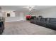 Spacious living room features a plush sectional sofa, carpeted floors and plenty of natural light at 8780 Flourish Dr, Land O Lakes, FL 34637