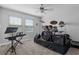Bedroom transformed into a music room, featuring a full drum set and keyboard at 8780 Flourish Dr, Land O Lakes, FL 34637
