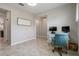 Functional home office showcasing a blue chair, two windows, and tile flooring at 8780 Flourish Dr, Land O Lakes, FL 34637