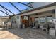 Spacious covered patio featuring a seating area and an outdoor television at 8780 Flourish Dr, Land O Lakes, FL 34637