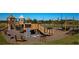 Community playground with wooden structures, slides, and swings for outdoor fun at 8780 Flourish Dr, Land O Lakes, FL 34637