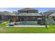 Beautiful shot of the pool in the screened lanai overlooking the spacious backyard at 8780 Flourish Dr, Land O Lakes, FL 34637