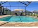 Swimming pool with an umbrella and houses in the background at 8780 Flourish Dr, Land O Lakes, FL 34637