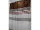 Close-up of shower curtain with modern stripes at 8780 Flourish Dr, Land O Lakes, FL 34637