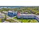 Aerial view of a lovely condo building with mature trees, lush landscaping and parking at 9950 62Nd N Ter # 319, St Petersburg, FL 33708