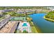 Stunning aerial view of the community featuring a pool, tennis court, and lake at 9950 62Nd N Ter # 319, St Petersburg, FL 33708