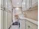 Bathroom featuring modern vanity with ample storage and a convenient laundry area at 9950 62Nd N Ter # 319, St Petersburg, FL 33708