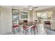 Cozy dining area featuring a ceiling fan, custom bench seating, and charming wall art at 9950 62Nd N Ter # 319, St Petersburg, FL 33708