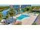 Aerial shot showcases the community pool with seating and a picturesque lake view at 9950 62Nd N Ter # 319, St Petersburg, FL 33708