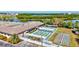 Overhead view of multiple shuffleboard courts with covered seating areas, and surrounding greenery and buildings at 9950 62Nd N Ter # 319, St Petersburg, FL 33708