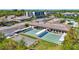 Aerial view showing shuffleboard courts within a community, featuring tidy landscaping and surrounding buildings at 9950 62Nd N Ter # 319, St Petersburg, FL 33708