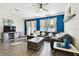 Bright living room with hardwood floors, a large sofa, a ceiling fan, and an accent wall at 10707 Avery Park Dr, Riverview, FL 33578