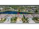Aerial view of a single-Gathering home featuring a pond, lush landscaping, and a well-maintained neighborhood at 11422 Captiva Kay Dr, Riverview, FL 33569