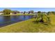 Backyard view overlooking a serene pond surrounded by lush green grass at 11422 Captiva Kay Dr, Riverview, FL 33569